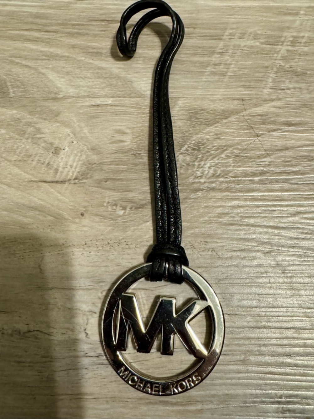 Michael Kors Logo Keychain: Chrome and Black. A chrome-plated pendant featuring